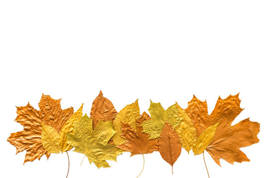 Autumn metallic gold copper silver leaves isolated on white. Different fall metallic paint leaves border frame on white background with copy space. Horizontal mockup with autumn leaves