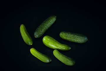 Cucumbers on black wood