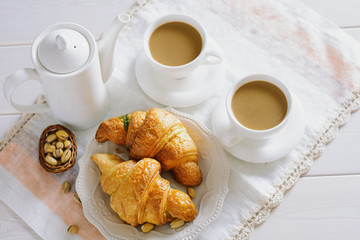 Fresh croissants for breakfast and coffee with milk