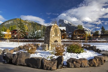 St. Mary Catholic Church Courtyard and Distant Snowcapped Rocky Mountains in City of Banff Canadian...