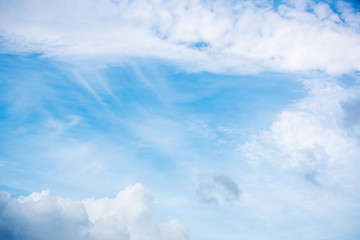 The sun shines on the sky from airplane, View on flight, bird  eye view.Over the Clouds. Fantastic background with clouds and mountain peaks