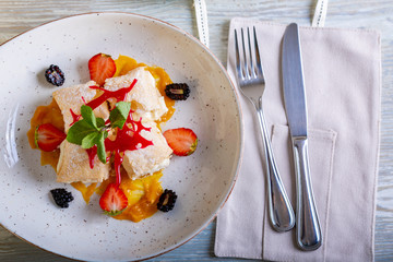 Close up view of beautiful elegant sweet dessert served on the plate. Beautiful decoration, restaurant dish, ready to eat. Tea time, cozy atmosphere.