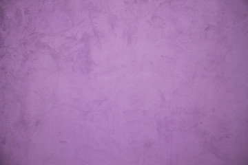 Shabby wall of lilac color. Purple wallpaper.