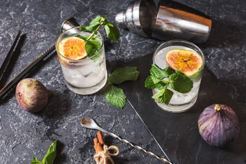 Pink fig alcoholic cocktail with cinnamon and mint