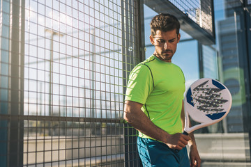 Sportsman resting from playing padel