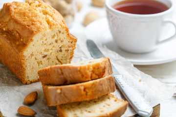 Sliced pound cake with almonds on the cutting Board. Homemade cake with nuts and honey.  Delicacy snack for tea