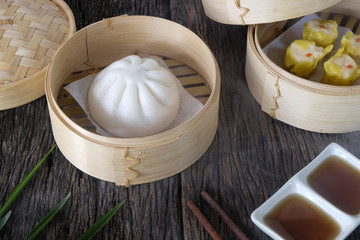Hot buns dim sum on wooden table.