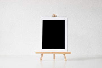 Mockup digital tablet on wooden stand and white isolated background.