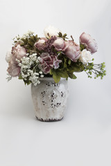 Bouquet of peonies in a vase on a white background.