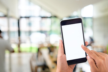 Mockup smartphone on female hands empty display on blur office background.