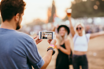 Man taking picture of female friends 