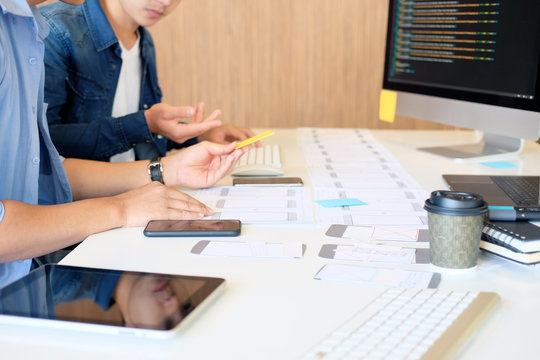 Programer Team working development software with UX UI project in computer and paper project.