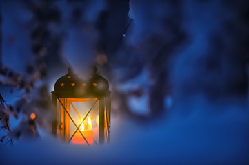 Candle lantern in the snow. Christmas time at dusk. © ekim