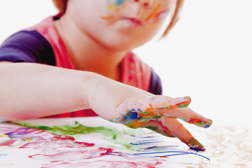little girl learning to paint (child development in art)