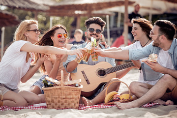 Group of friends having a party on the beach