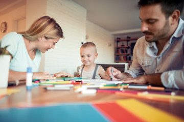 Young parents with child drawing