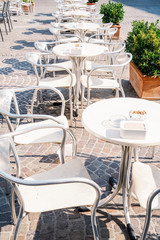 tables and chairs in an alfresco cafe in the european city