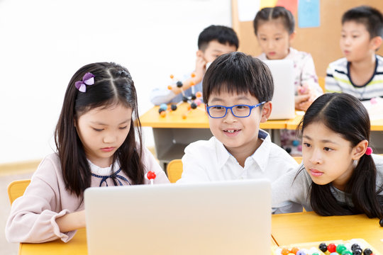 Elementary school students use computers in the classroom
