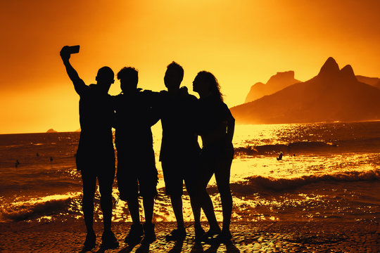 Group of tourists taking selfie at beach at Rio de Janeiro