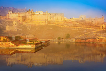 Fototapeta na wymiar Amber Fort in Jaipur, Rajasthan, India in the early morning with mist, on sunrise, with reflection on a lake.