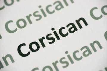 Fototapeta premium word Corsican language printed on paper macro