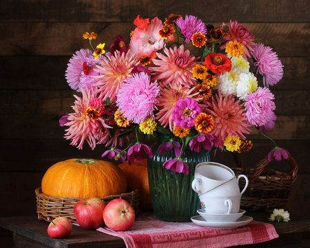 Autumn still life with flowers and fruits in rustic style.