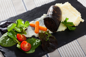 Black pudding served with mashed potatoes