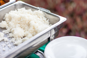 white rice in silver tray for catering lunch and dinner. buffet set in wedding ceremony.main food cabohydrate, high calories of Asia.