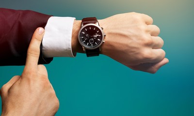 Businessman with hand watch on background, close-up
