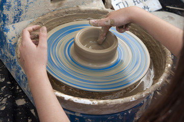 making pottery by hands on a Potter's wheel