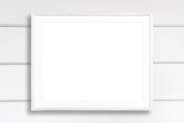 Fototapeta premium Blank white picture frame on white wood background.