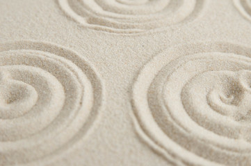 Fototapeta na wymiar Zen drawing on white sand. Concept of harmony, balance and meditation, spa, massage, relax