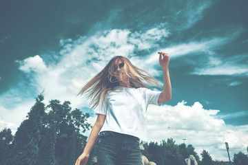 Fototapeta na wymiar Freedom young woman carefree with open arms to blue sky
