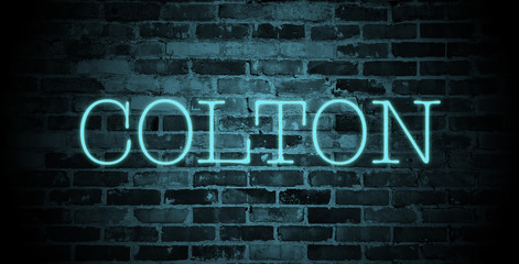 Fototapeta na wymiar first name colton in blue neon on brick wall