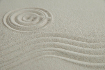 Fototapeta na wymiar Zen drawing on white sand. Concept of harmony, balance and meditation, spa, massage, relax