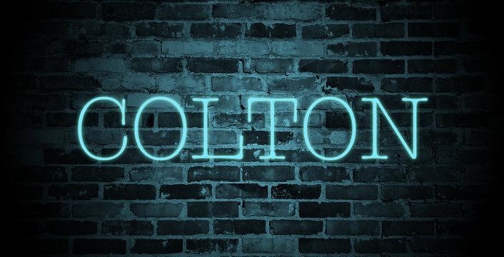 first name colton in blue neon on brick wall
