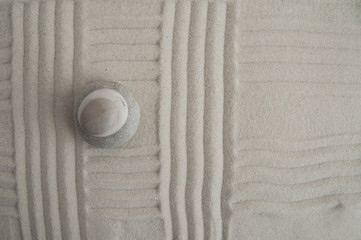 Pyramids of gray zen stones on the sand with wave drawings. Concept of harmony, balance and...