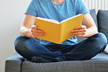 men reading in book - close up