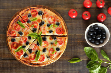 Sliced pizza with tomato and olives