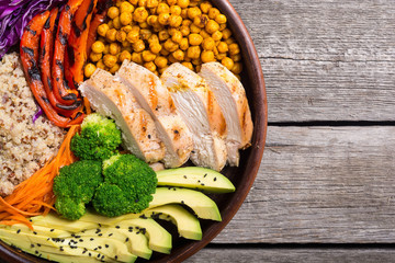 Buddha bowl with avocado , chicken , pepper , quinoa and chickpea
