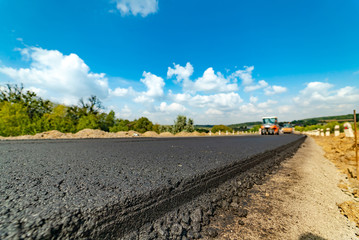 workers carry out construction and repair works of roads with the help of professional equipment...
