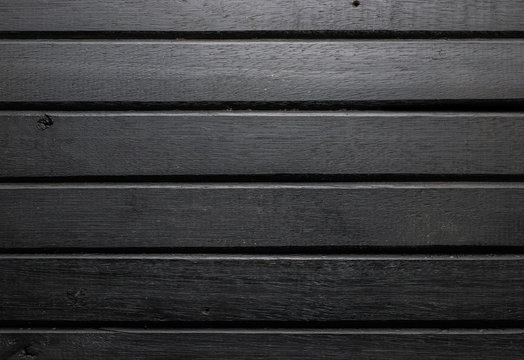 Black wood table background, lots of contrast, wooden texture