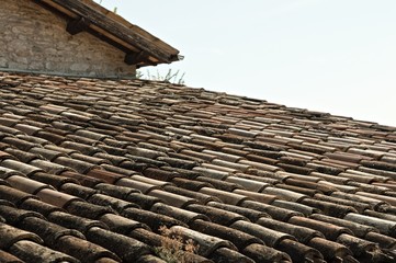 Tiles detail of an old italian roof - Architectural background (Marche, Italy, Europe)