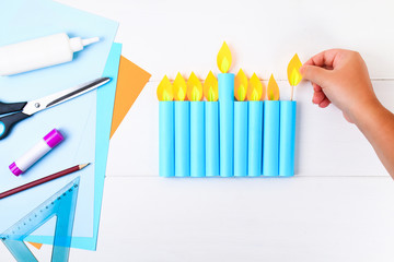 DIY. A paper menorah with his own hands made of paper. Menorah for the Jewish holiday Hanukkah. Handmade for the child.
