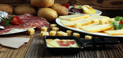 Delicious traditional Swiss melted raclette cheese on diced boiled or baked potato.