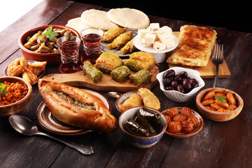 Middle eastern or arabic dishes and assorted meze, concrete rustic background. sambusak. Turkish Dessert Baklava with pistachio. Sarma. Halal food. Lebanese