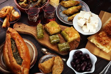 Middle eastern or arabic dishes and assorted meze, concrete rustic background. sambusak. Turkish Dessert Baklava with pistachio. Sarma. Halal food. Lebanese