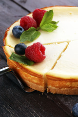 Homemade cheesecake with fresh raspberries and mint for dessert - healthy organic summer dessert pie cheesecake. Vanilla Cheese Cake