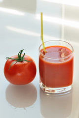 Glass of fresh tomato juice and tomato