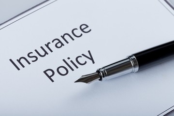 Fountain Pen Lying on the Document of Insurance Policy - Close